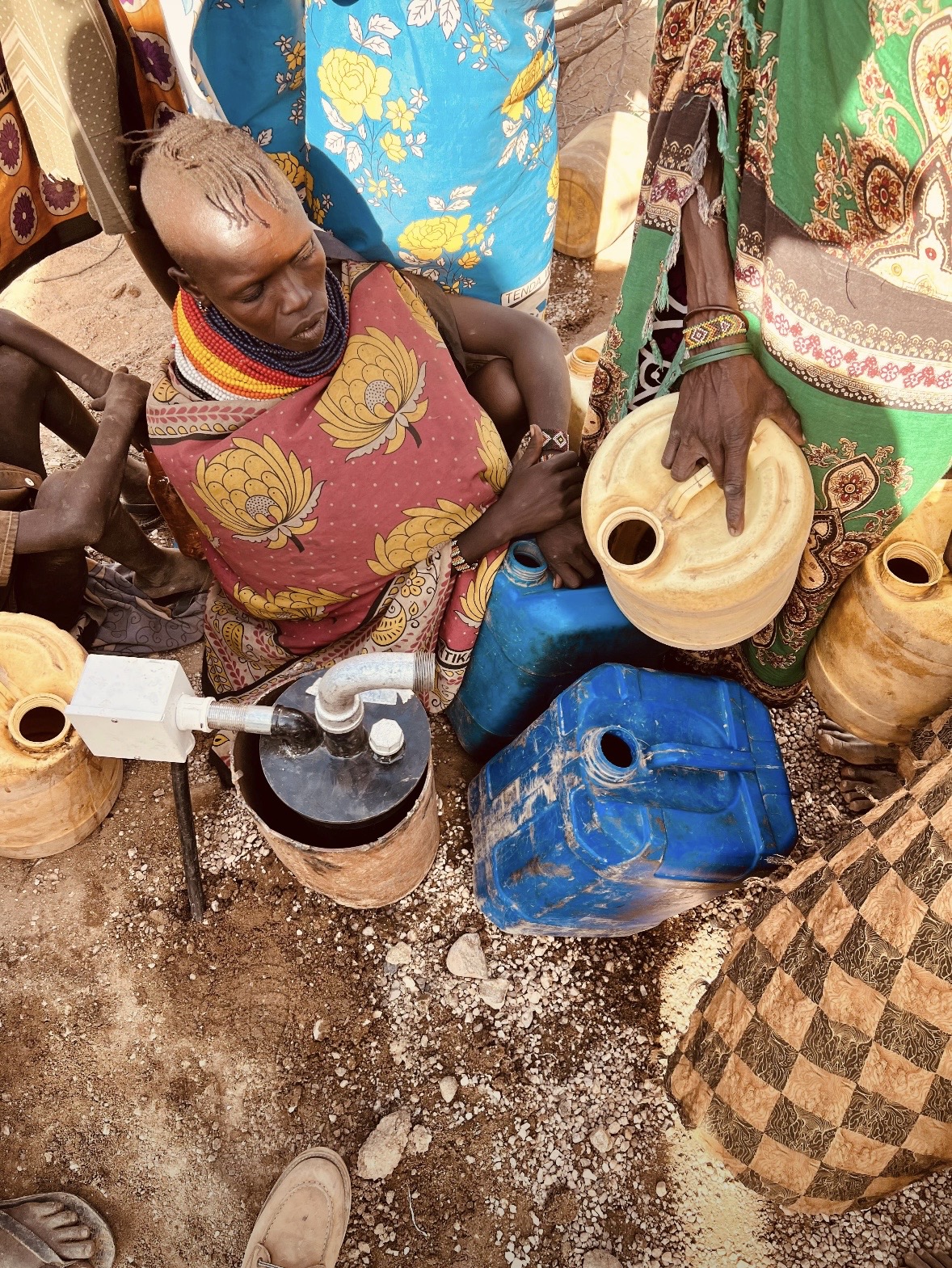 Chumvi community gathered around the borehole with jerrycans waiting for first water Kisima Laikipia