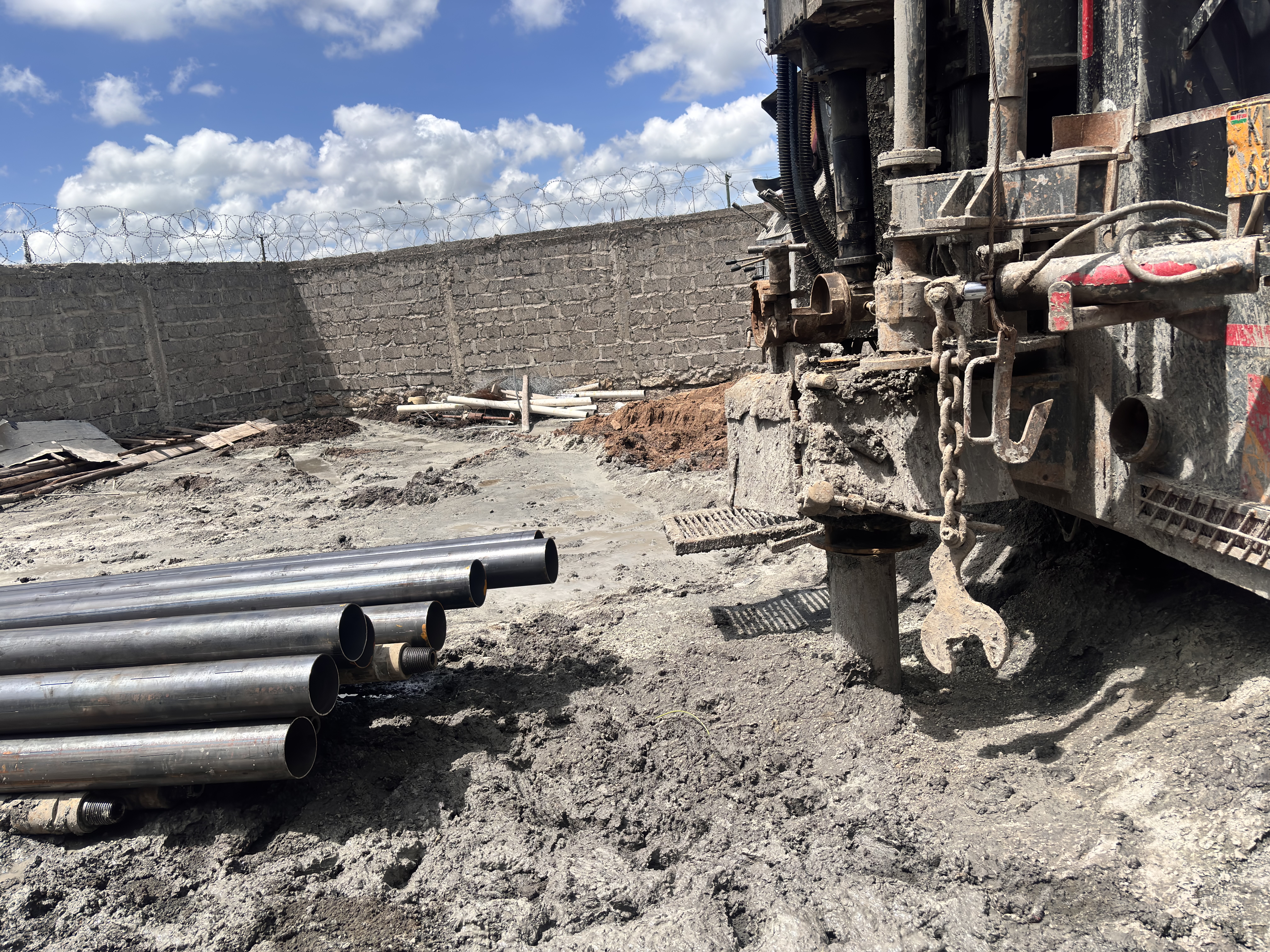 Drilling crew advancing borehole through clay